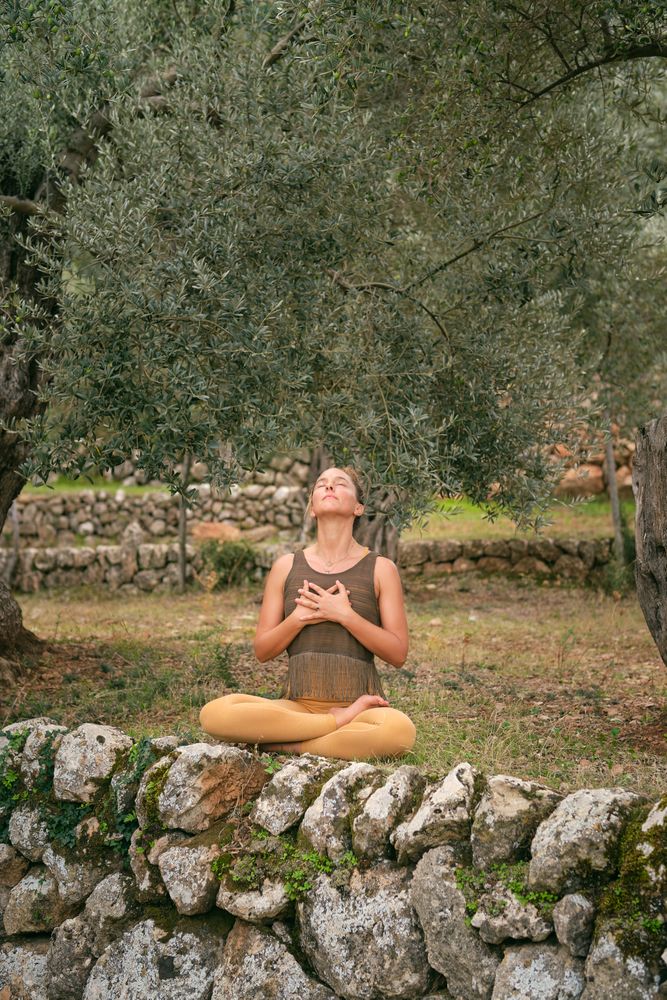 Woman meditating and breathing in park