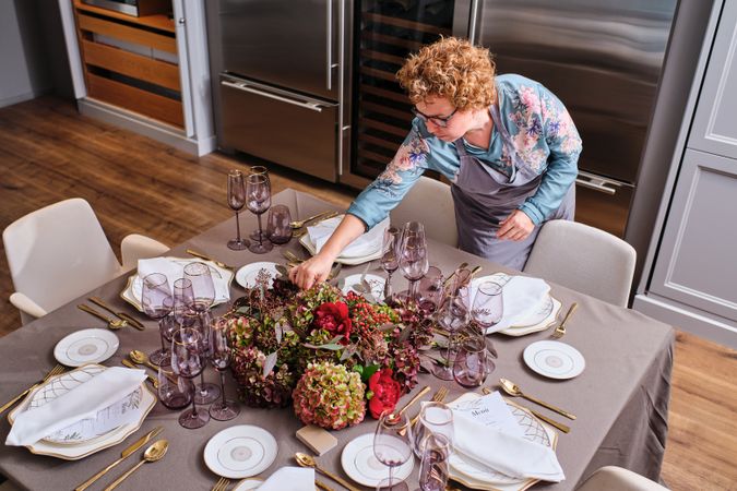 Woman decorating table with flowers