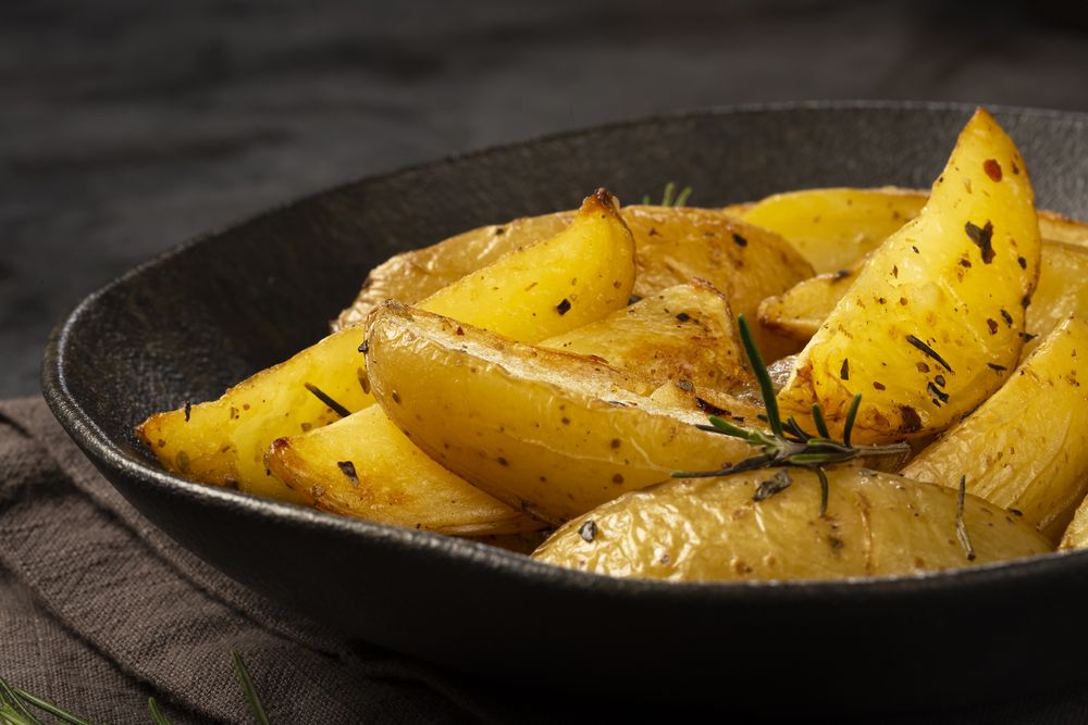 Roasted potatoes with rosemary on the plate.