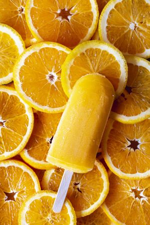 Ice cream popsicle on orange slice background