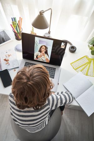 Boy having video chat with girl playing flute