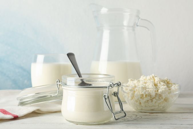 Different dairy products on wooden background, copy space