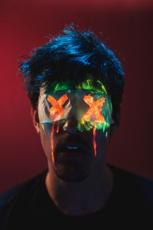 Male with covered eyes and neon face