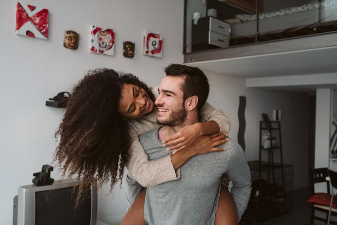 Multiracial couple having fun at home