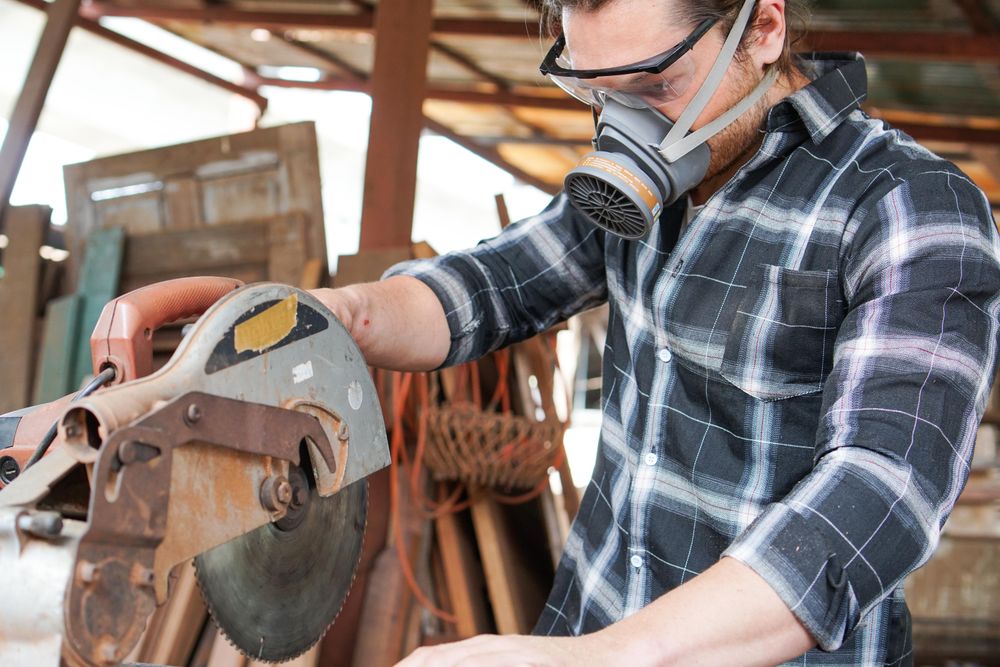 Man with circular saw in a wood shop