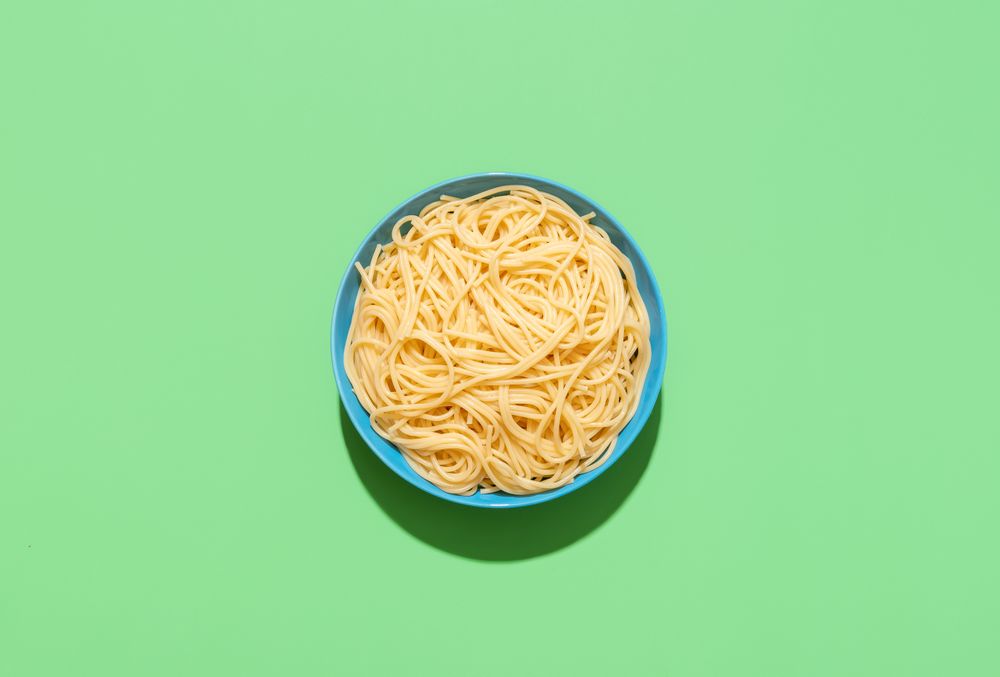 Spaghetti top view on a green background
