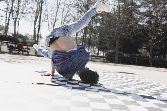 Man dancing break dance in park