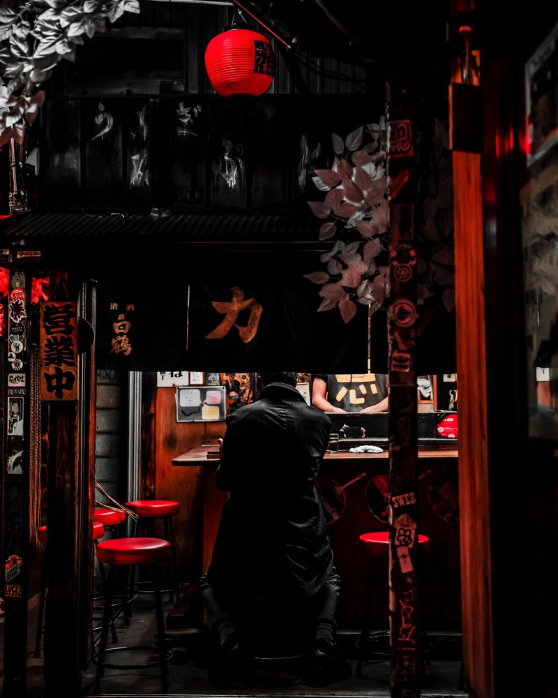 Back view of a man standing in a bar