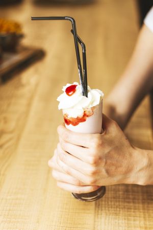 ice cream in paper cone in hands