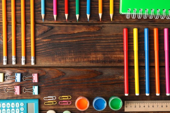Flat lay composition with school supplies on wooden background, space for text