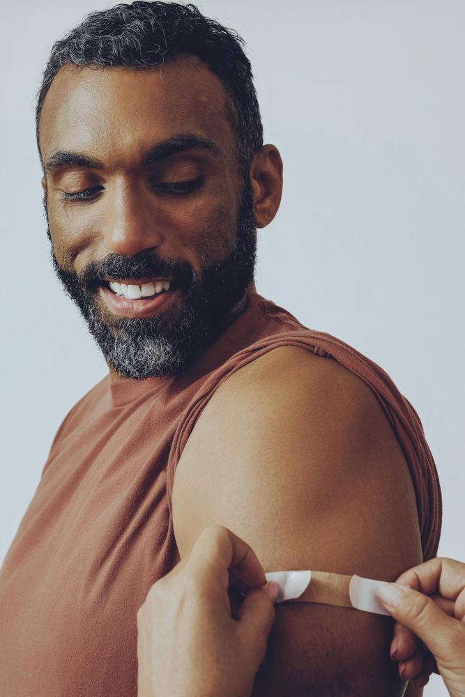 Man having bandaid placed after injection