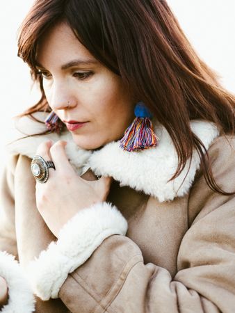 Portrait of thoughtful model with handmade earrings