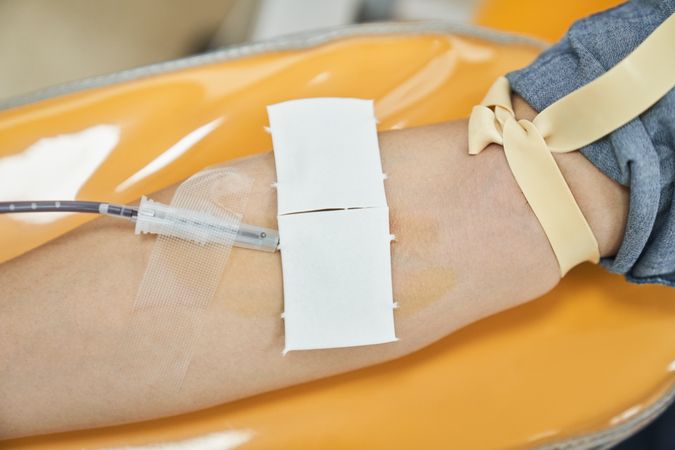 Anonymous woman giving blood from vein