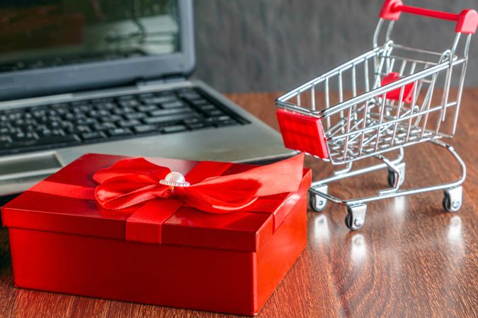 E-Commerce Shopping Concept with Gift Box and Laptop Setup