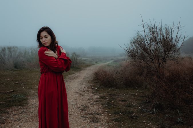 Woman in red dress walking in foggy area