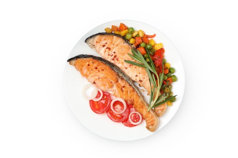 Plate with grilled salmon isolated on blank background