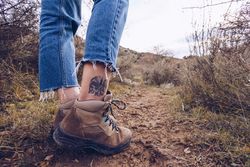 Hipster tourist walking along rural field