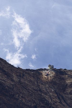 Anonymous man climbing rock