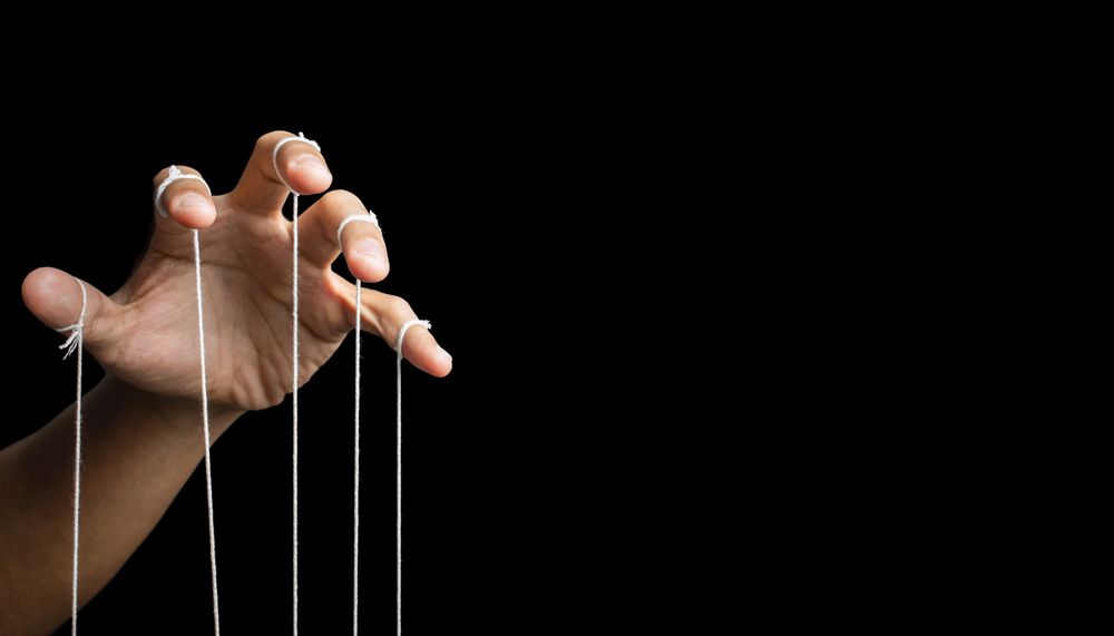 male puppeteer hand with strings