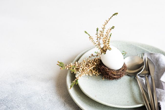 Easter table setting with decorative nest & egg, with heather on plates