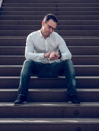 Man checking time on stairs