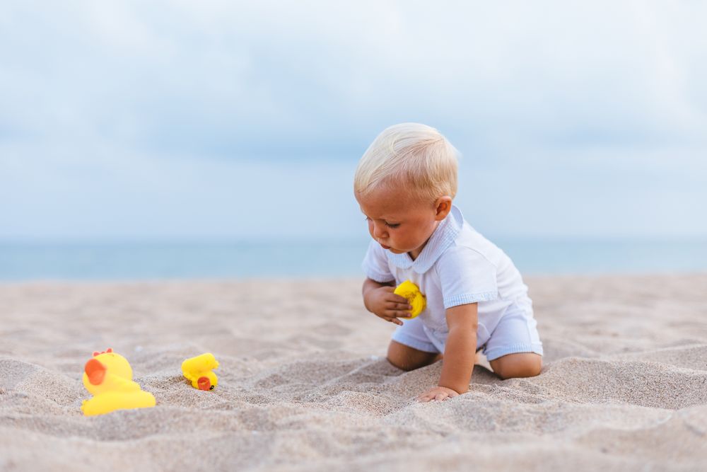 Baby boy playing with rubber ducks