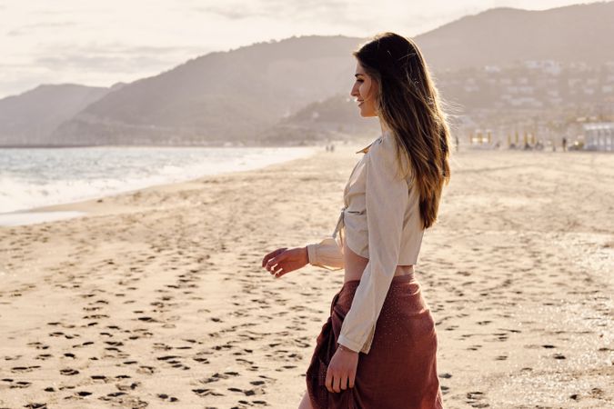 A fashion model at the beach before sunset