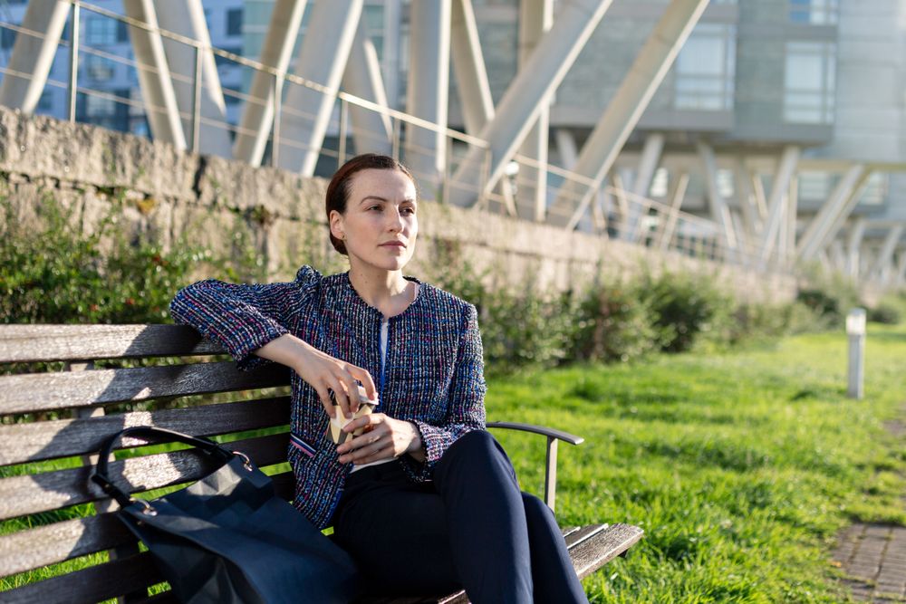 Businesswoman drinking on city street