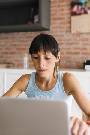 Woman concentrating while working at laptop