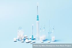 Variety of pharmaceutical items on blue backdrop 5QAEE5