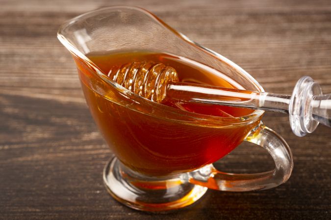 Honey in glass bowl on the table.