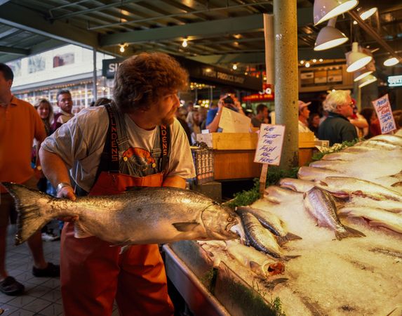 A "fish thrower" at the Pike Place Fish Company, Seattle Washington