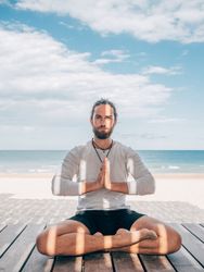 Man meditating on beach