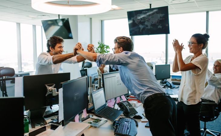 Business people celebrating success in office