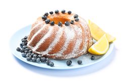 Cake with powdered sugar, blueberry and lemon isolated on plain background