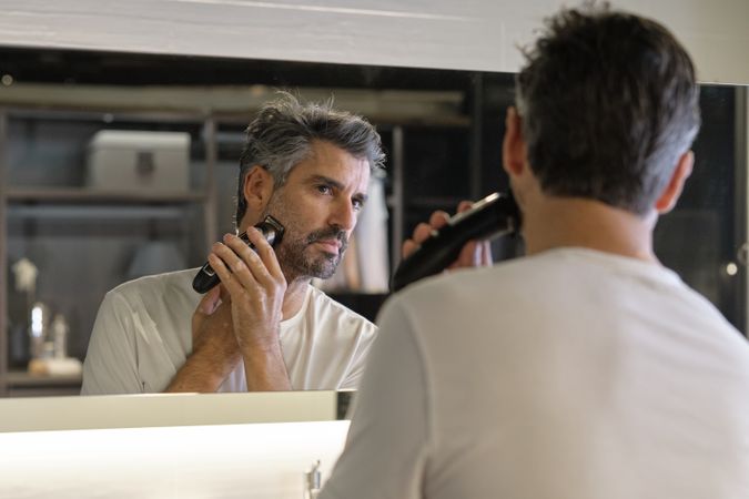 Man shaving in bathroom at home