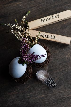 Close up of heather in decorative eggs for Easter on wooden table