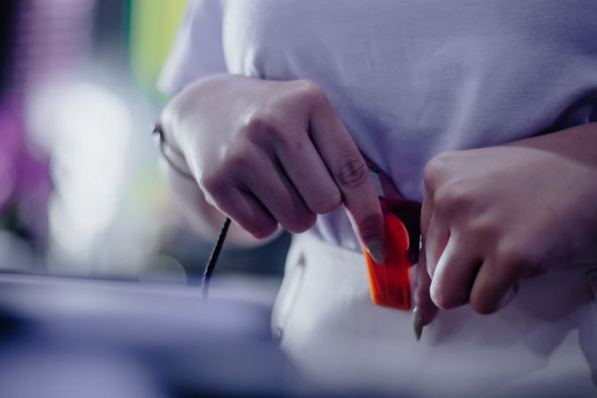 Intricate focus showcasing a hand carefully adjusting a cable