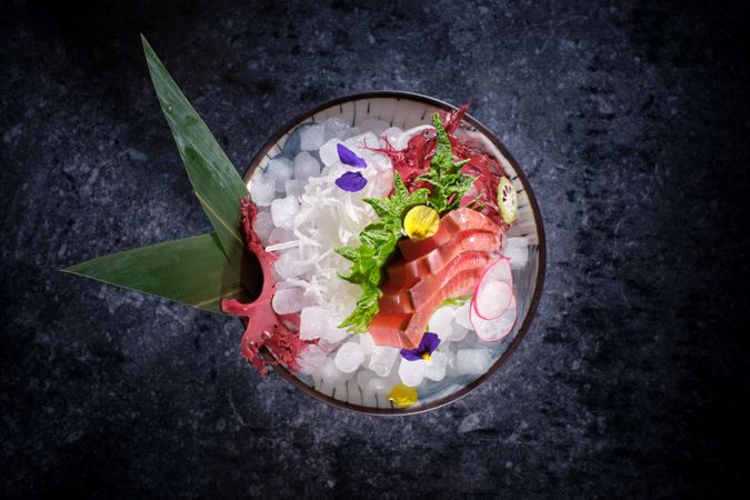 Ceramic plate with raw fish and vegetables