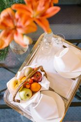 Bouquet and tray on table in hotel room