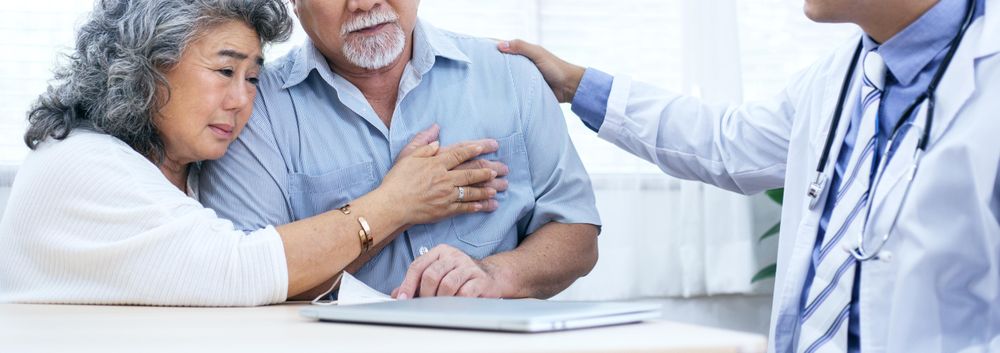 Sad mature couple hearing worrying news from doctor