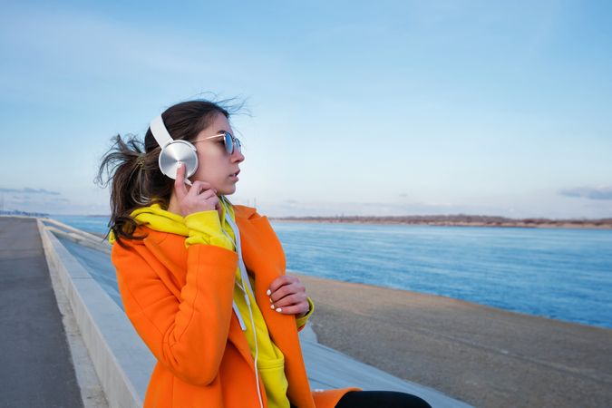 Woman with headphones looking out to the coast