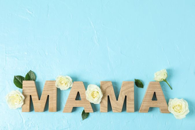 Inscription Mom with roses on color background, space for text