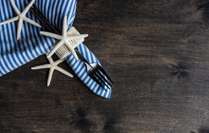 Top view of coastal table setting with sea stars on wooden table