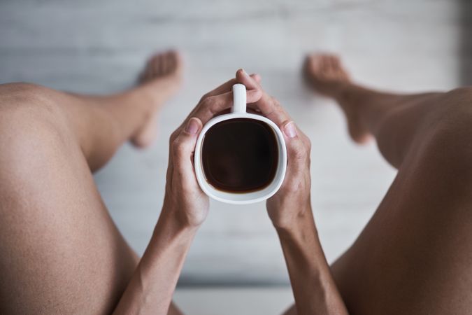 Unrecognizable woman with coffee cup at home