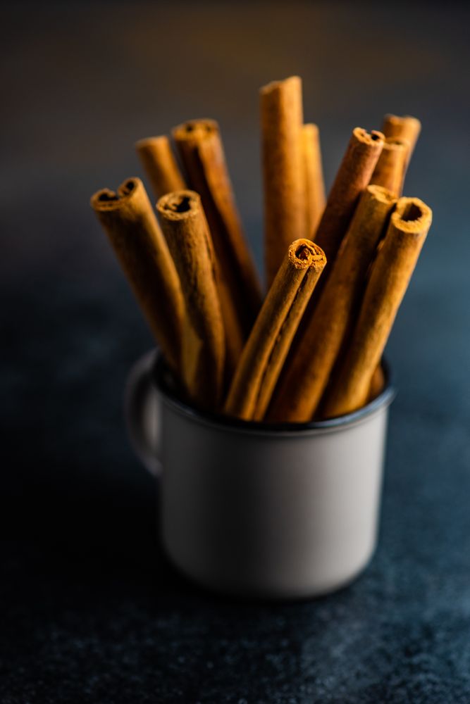 Side view of cinnamon sticks in container