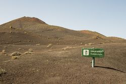 Caution sign near hill slope
