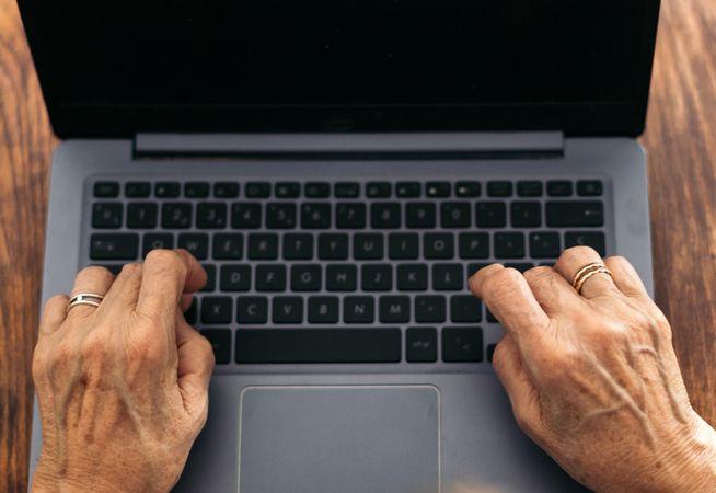 Unrecognizable older woman using the laptop