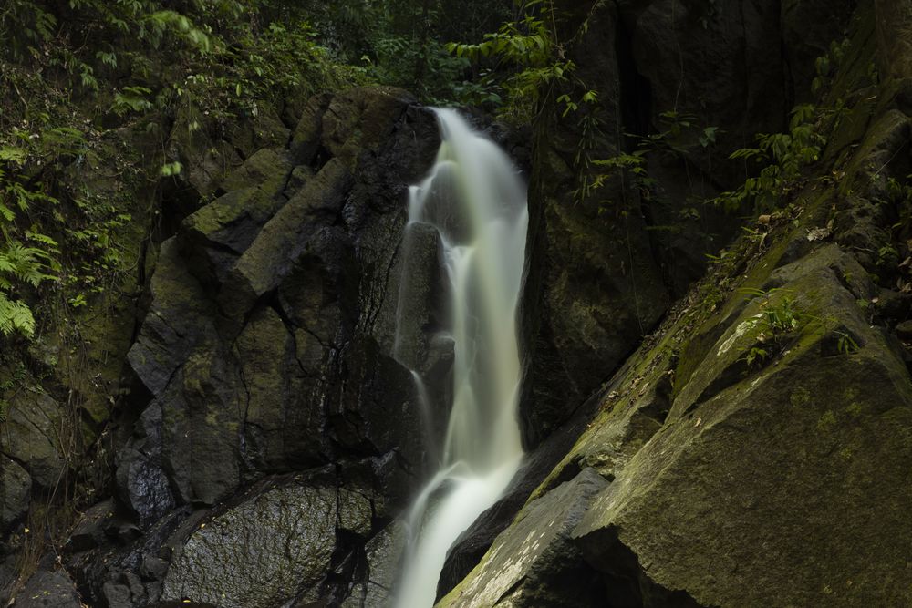Pria Laot waterfall, hidden between rocks and moss, Pulau Weh island, Sumatra, Indonesia