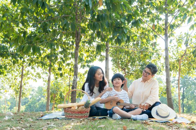 Asian family having fun together at park on weekend